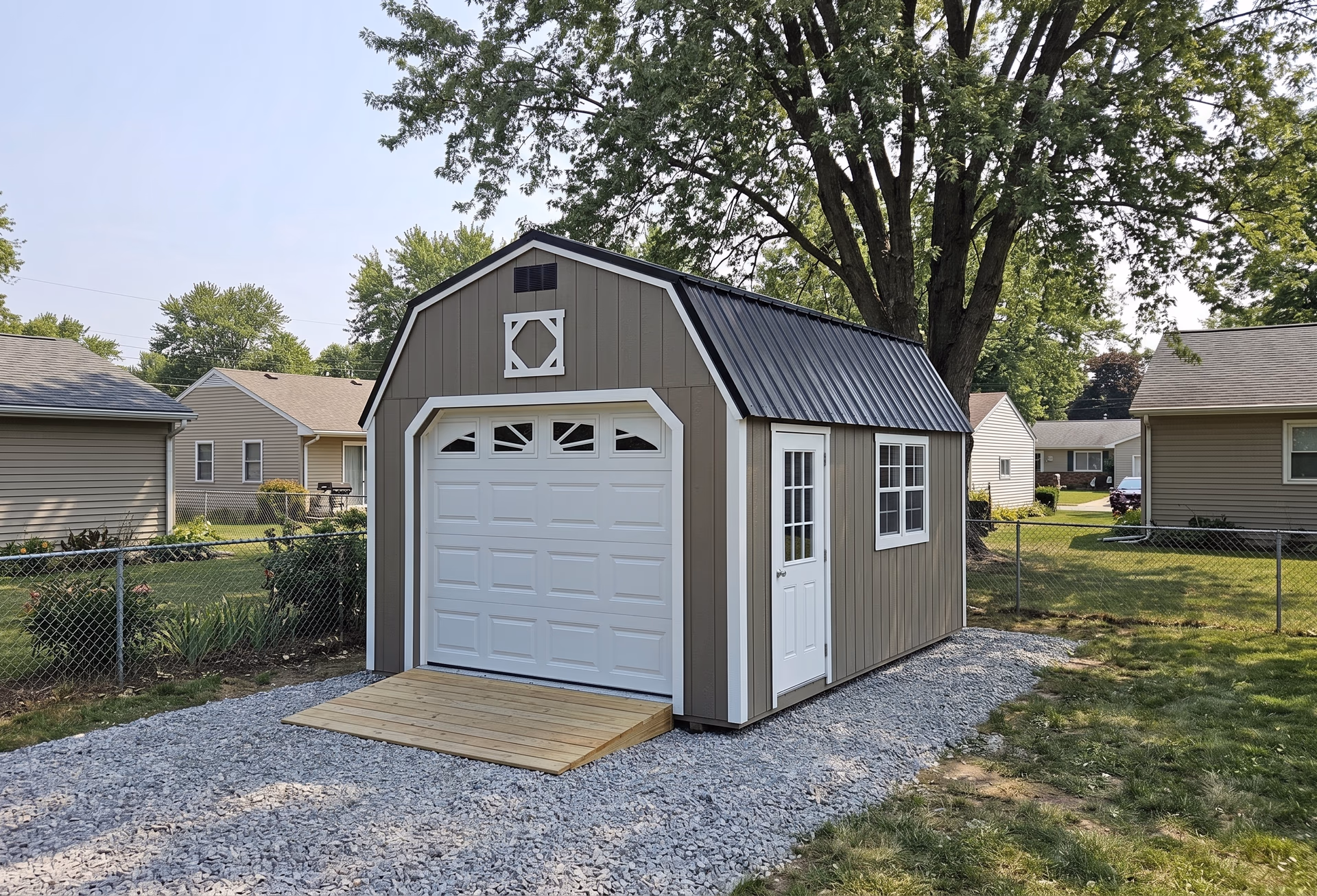 LP SmartSide lofted garage with a sunburst gable on a green lawn